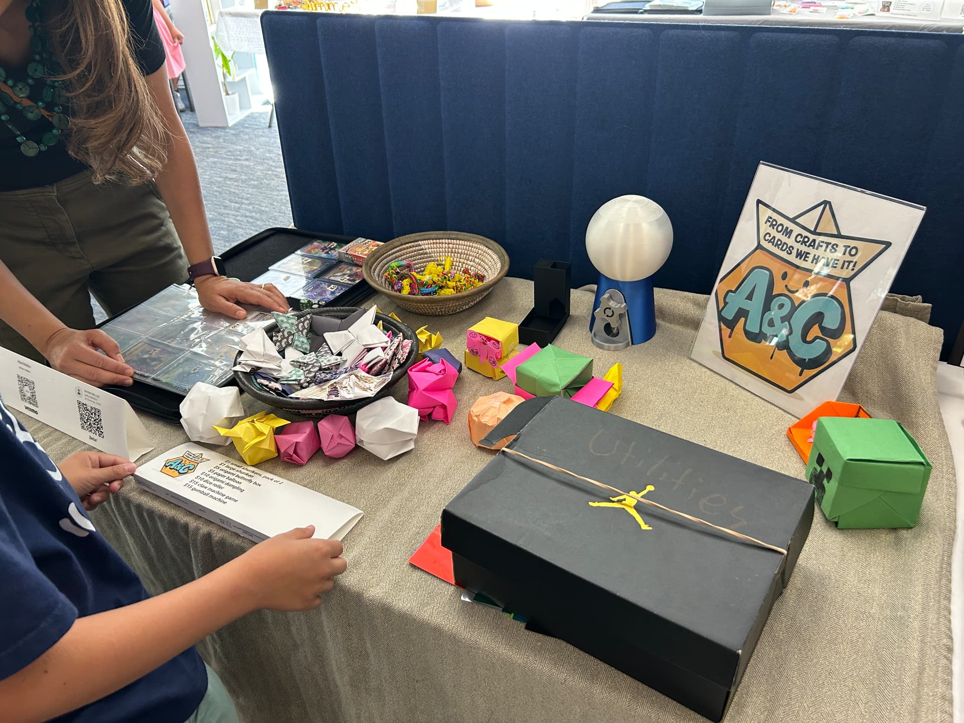 A&C booth displaying origami and trading cards
