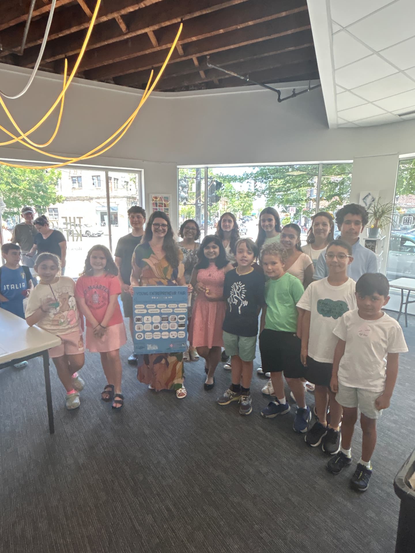 Young entrepreneurs with Marie at the June 2026 fair in The Idea Kitchen